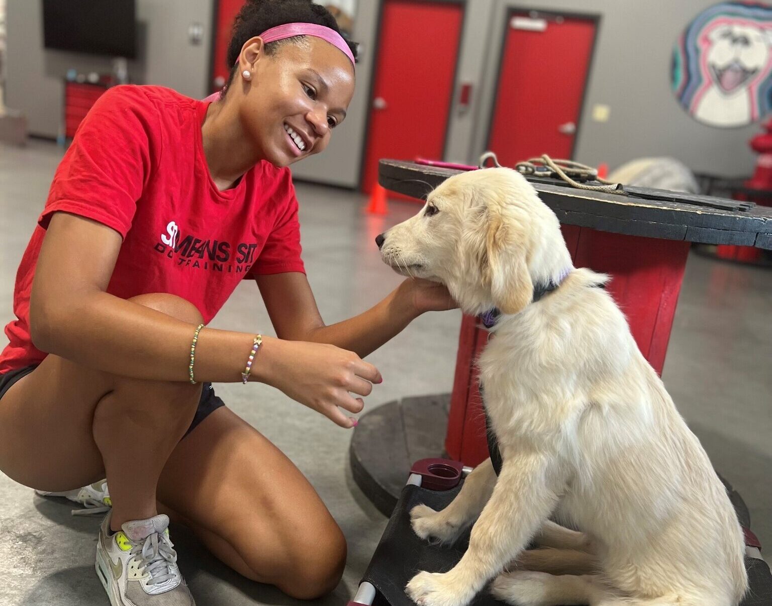 Sit Means Sit Cincinnati dog trainer smiling at golden retriever