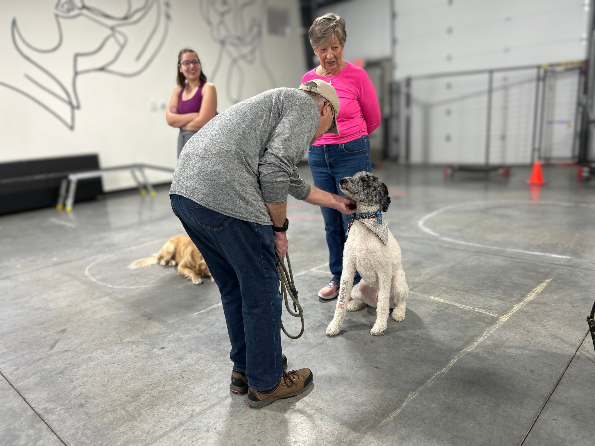 Owners training with their dog at facility
