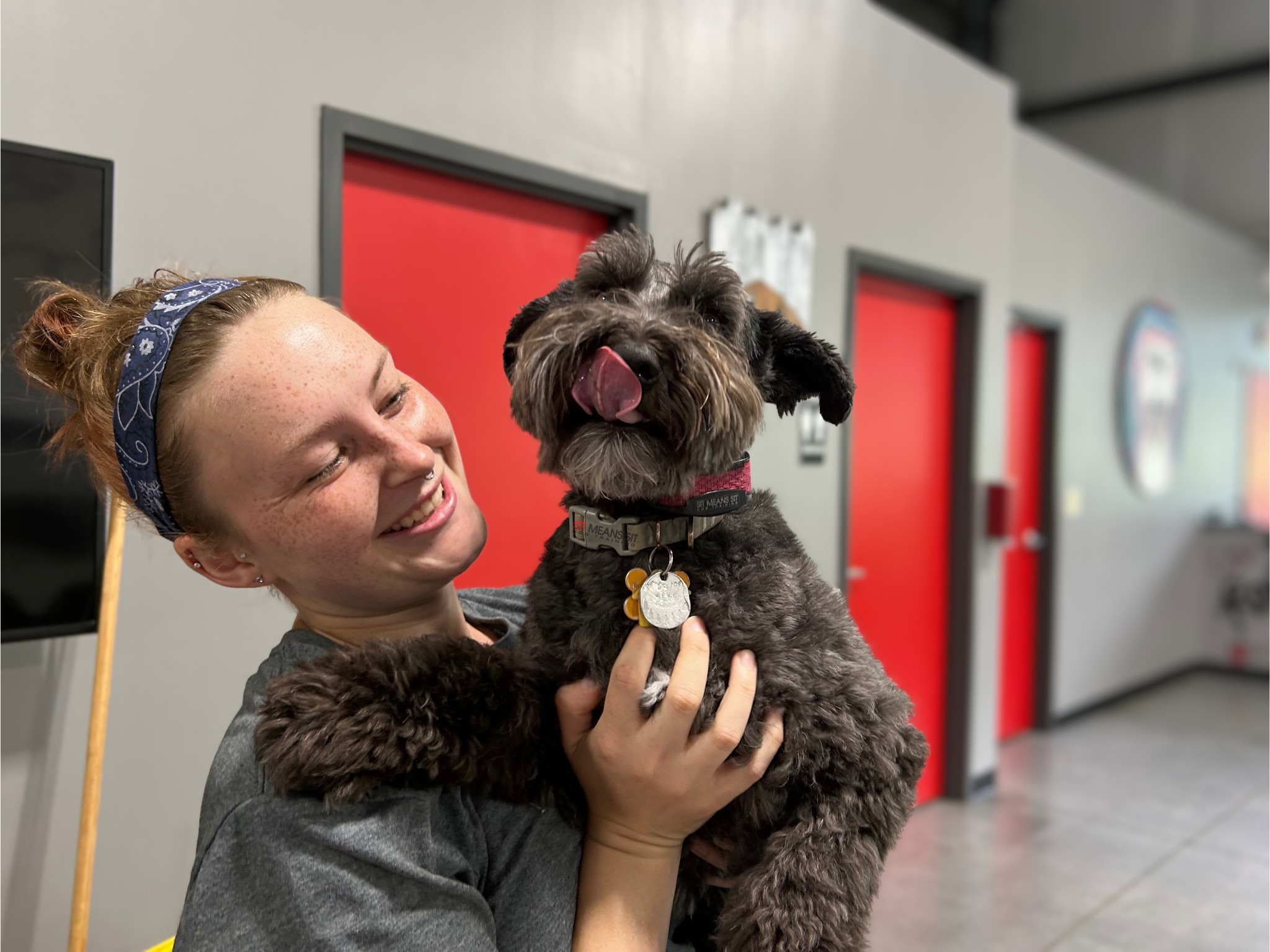 Trainer holding dog during class